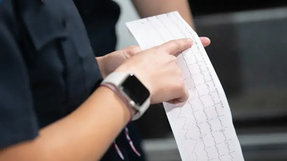 A hand pointing to a specific data point in a medical graph.