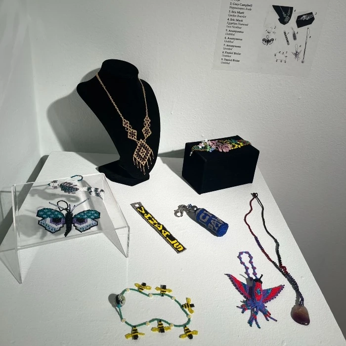 beaded jewelry made by PEI interns, featuring necklaces, keychains, and insects
