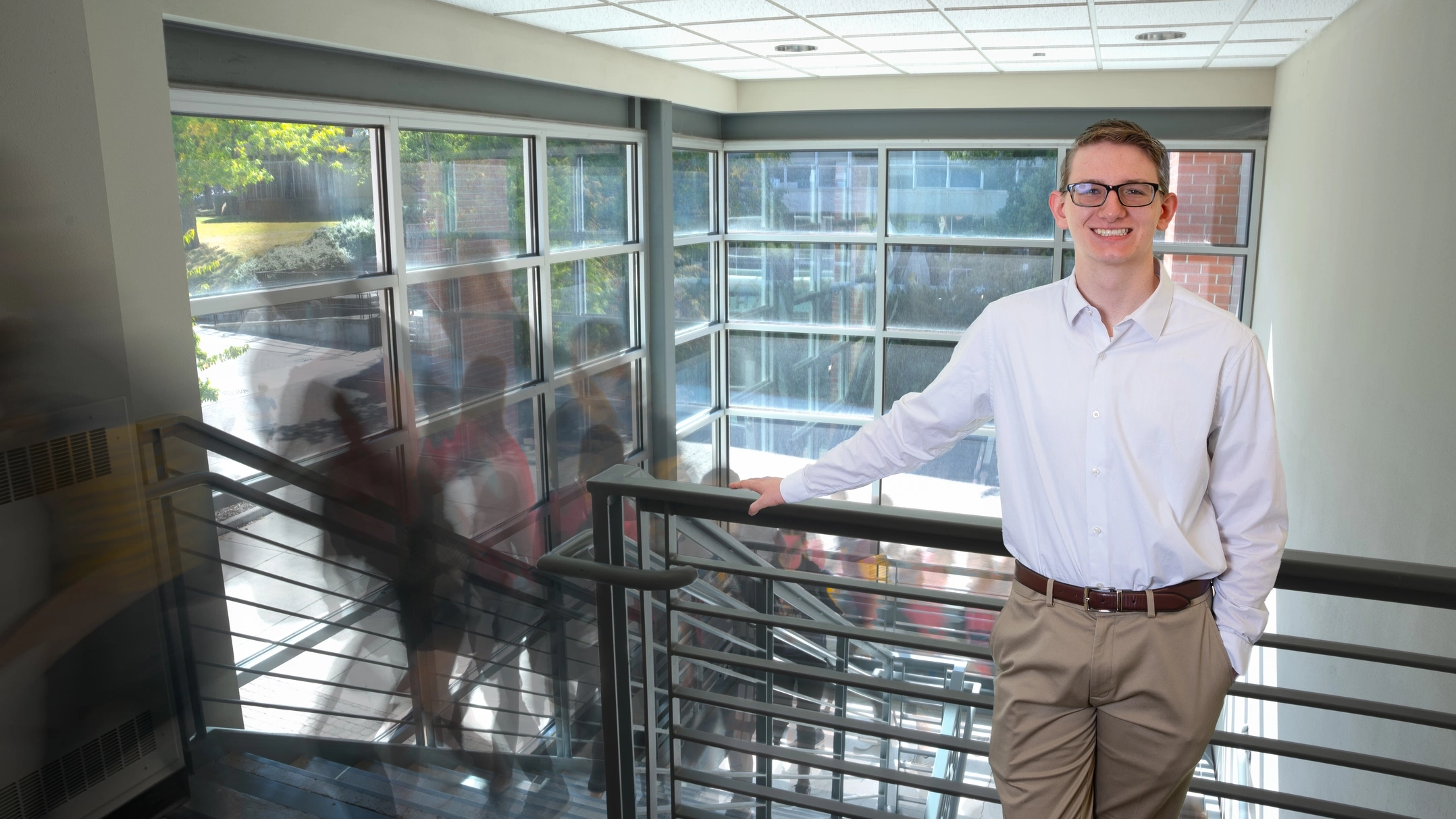 Austin Smith at the top of the stairs in the business building