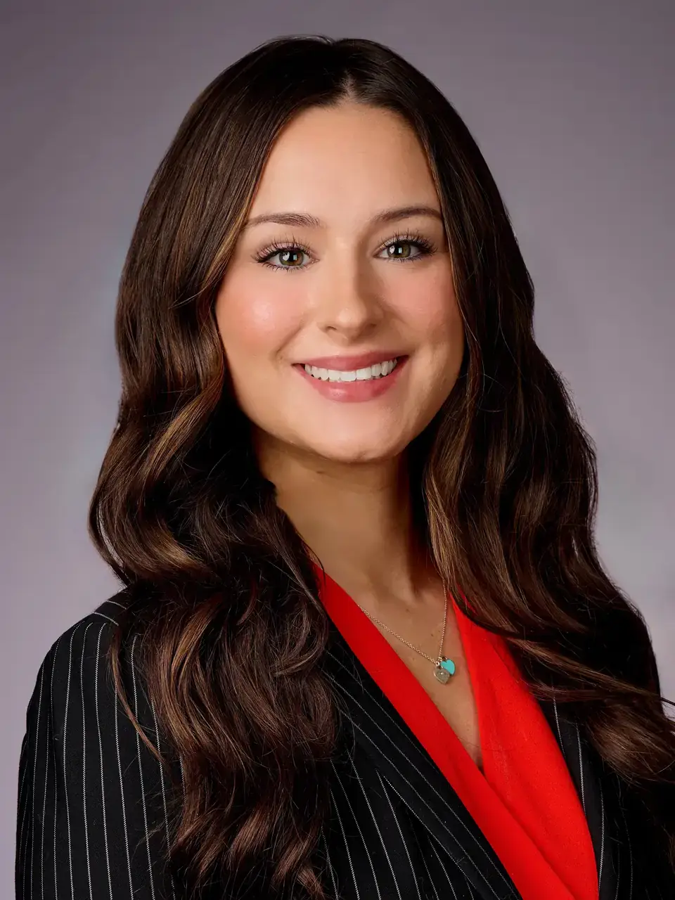 Portrait of law student Kalista Barkley in a red blouse and black, pin-striped blazer