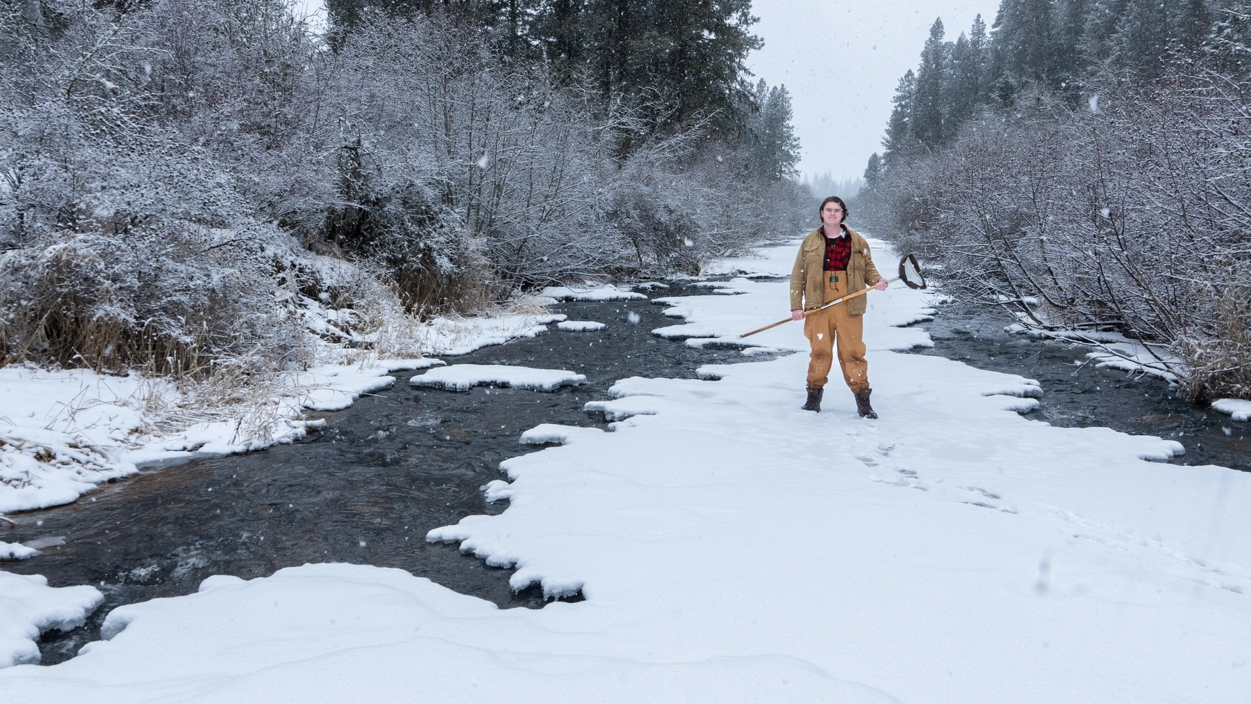 Fisheries student Jack Stafford earned a scholarship to study insects in streams. He is pictured collecting aquatic insects in a stream near Potlatch, Idaho.