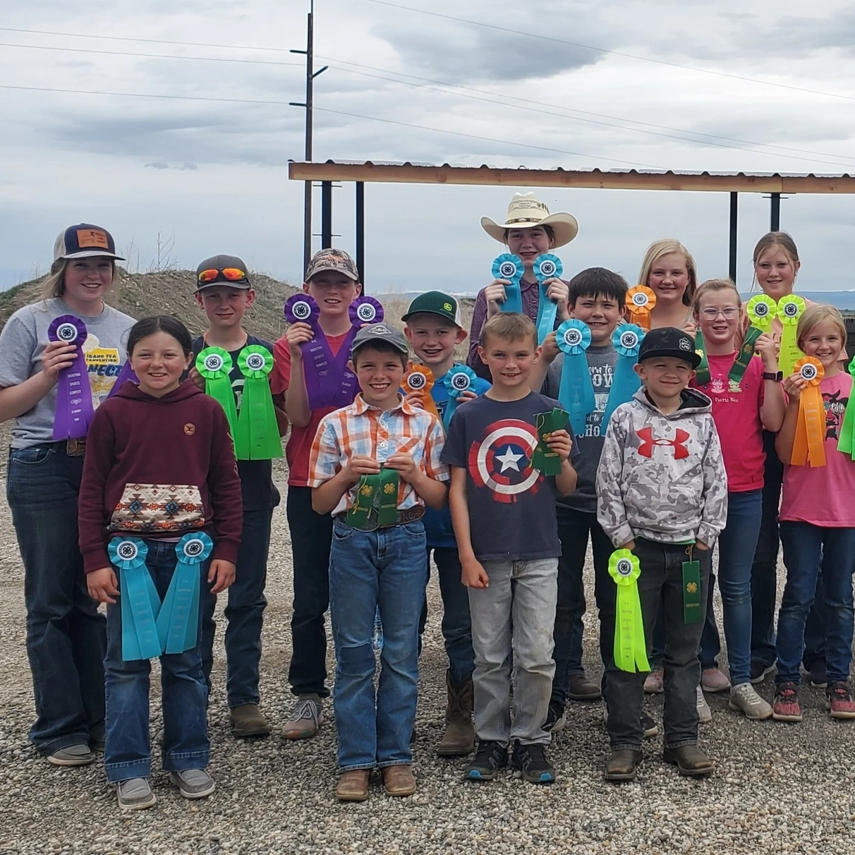 A group of children display ribbons.
