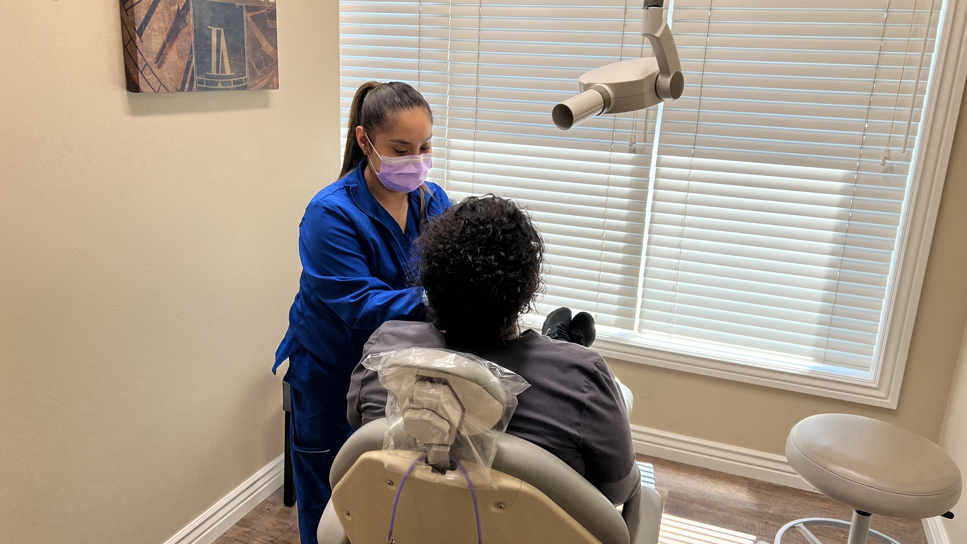A woman taking dental films of a patient in a dentist office