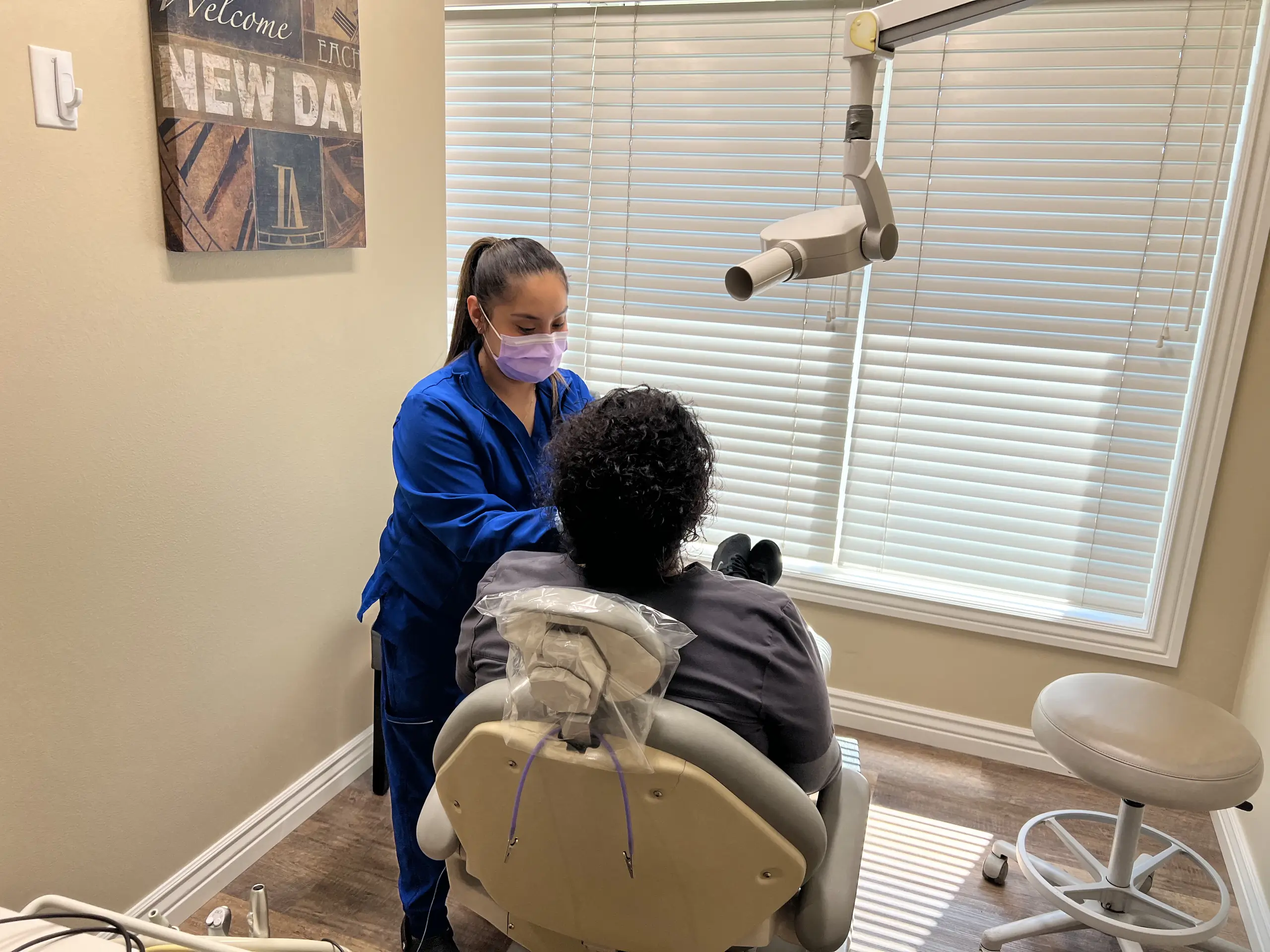 A woman taking dental films of a patient in a dentist office