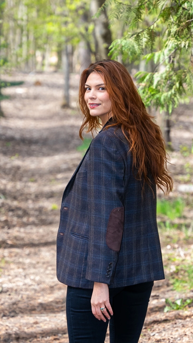 Celilo Miles looks back over her shoulder while walking in the woods